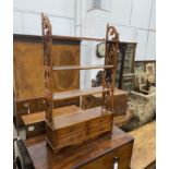 A reproduction George III style mahogany four tier wall bracket, the base fitted with two drawers,
