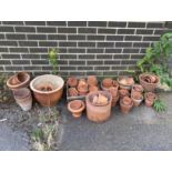 A large quantity of assorted terracotta and earthenware garden pots, largest diameter 37cm, height