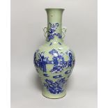 A large Chinese celadon glazed vase with twin handles, decorated in relief with figures and bats,