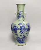A large Chinese celadon glazed vase with twin handles, decorated in relief with figures and bats,