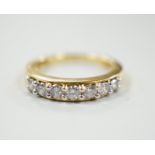 A modern 18ct gold and seven stone diamond set half hoop ring, total carat weight 0.50ct, size J,