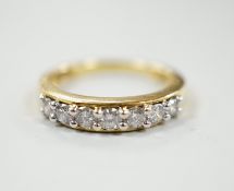 A modern 18ct gold and seven stone diamond set half hoop ring, total carat weight 0.50ct, size J,