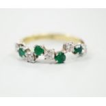 A modern 18ct gold, four stone emerald and five stone diamond set wavy half hoop ring, size O, gross