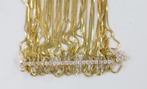 A yellow metal multi strand necklace, with thirty stone diamond set central line motif, 50cm,