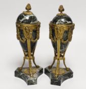 A pair of Regency style green marble and gilt metal cassolettes, decorated with bows and swags, each