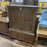 A George III panelled oak hanging cupboard, width 126cm, depth 50cm, height 165cm