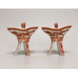 A pair of Chinese iron-red dragon vessels, jue, (boxed), 10cm high