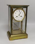 An early 20th century French brass four-glass mantel clock with enamel dial inscribed Garnier,