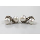 A modern pair of white metal, two stone cultured pearl and seven stone diamond set crossover