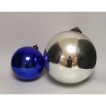 A Victorian silvered witch's ball and a smaller blue glass witch’s ball, the largest approximately
