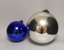 A Victorian silvered witch's ball and a smaller blue glass witch’s ball, the largest approximately