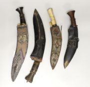 A kukri within white metal mounted sheath, blade 27cm, and three others, one with bone handle