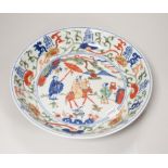 A Chinese wucai shallow dish hand painted with figures and flowers, housed in a fitted case, 23cm in