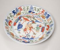 A Chinese wucai shallow dish hand painted with figures and flowers, housed in a fitted case, 23cm in