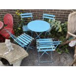 A circular metal folding garden table, diameter 60cm, height 71cm, and four folding chairs