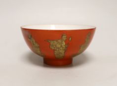A Chinese coral red ground bowl, gilded with figures, 14cm diameter