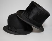 A black silk Dunn and Co top hat (boxed) and a black bowler hat by the same retailer (boxed)