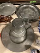 Two pewter chargers one crested, eight plates and a jug, 18th century and later, largest charger