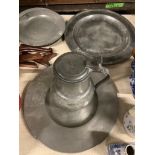 Two pewter chargers one crested, eight plates and a jug, 18th century and later, largest charger