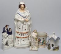 A tall Staffordshire pottery figure of Queen Victoria, a Staffordshire 'frog' mug, a square base