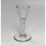 An English lead crystal facetted drawn trumpet wine glass, with facets extending into the bowl and