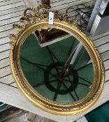 A pair of Victorian style gilt and composition oval mirrors, width 48cm, height 65cm