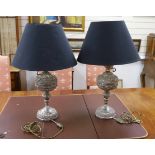 A pair of plated repousse worked table lamps with black shades, 70cm high including shades