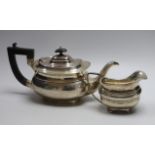 A George V silver teapot, Birmingham, 1921 and a George V silver cream jug, Elkington & Co,
