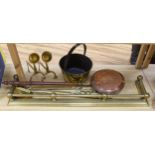 Brassware including fire kerb, fire tools, arts and crafts fire dogs and a copper warming pan, the