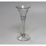 An English lead crystal drawn trumpet wine glass, c.1740, with tool marks to the bowl and a long