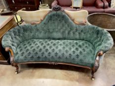 A Victorian walnut settee upholstered in green fleur de lys buttoned fabric, length 190cm, depth