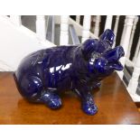 A large seated blue glazed pottery pig, 53cms wide