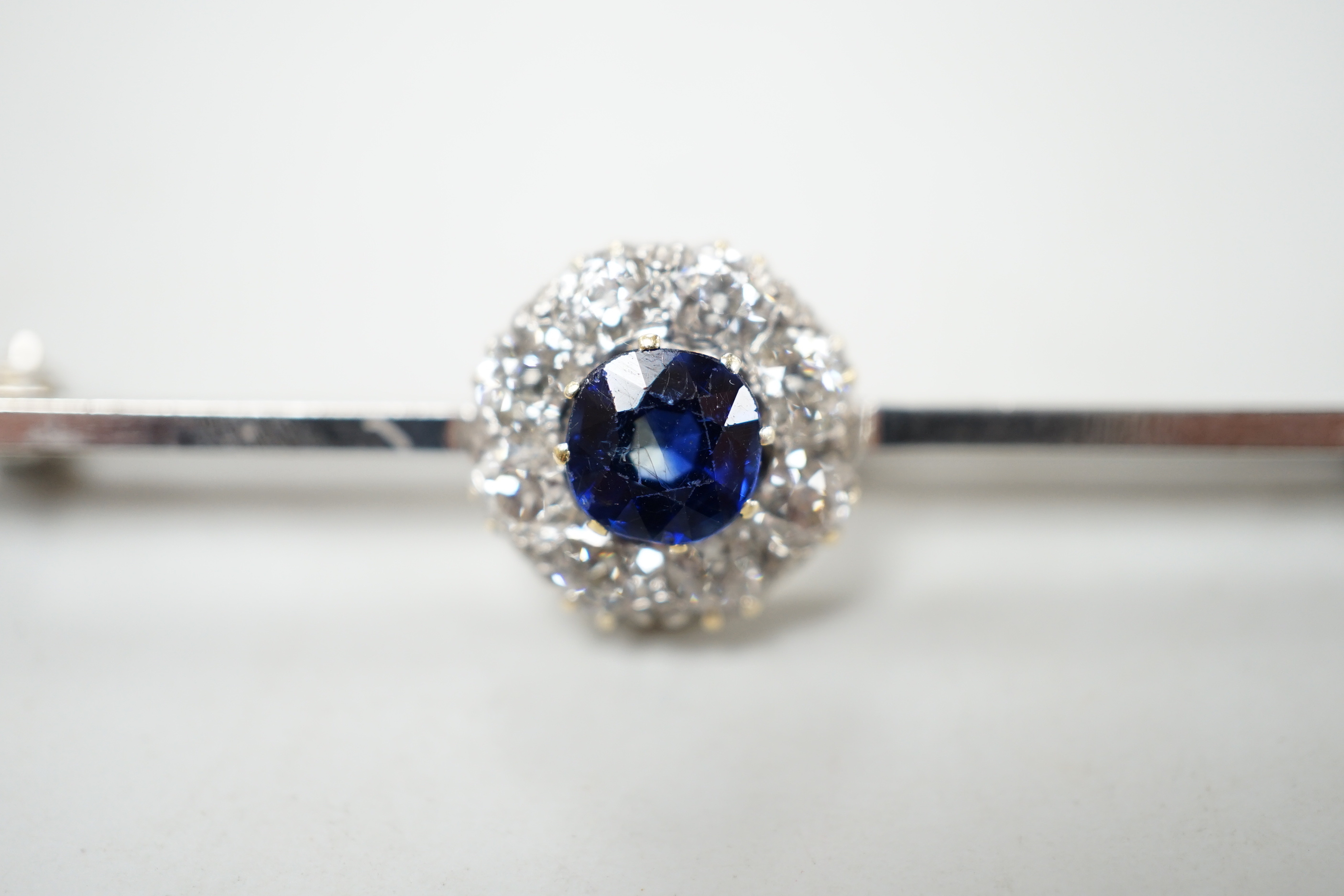 A mid 20th century white metal, sapphire and diamond cluster set bar brooch, 55mm, gross weight 4. - Image 3 of 4