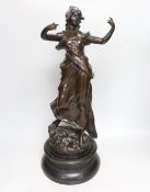 A large bronzed spelter figure of a female on an ebonised wooden base, height 55cm