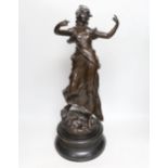 A large bronzed spelter figure of a female on an ebonised wooden base, height 55cm