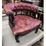 A late Victorian ebonised buttoned burgundy leather tub framed chair, width 66cm, depth 67cm, height