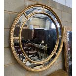 A Victorian style circular gilt composition marginal plate wall mirror, diameter 111cm