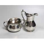 An Elizabeth II silver sugar bowl and a cream jug, by Rodney Clive Pettit, London, 1997, jug