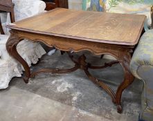 An early 20th century French rectangular oak centre/dining table with shaped 'X' stretcher, length