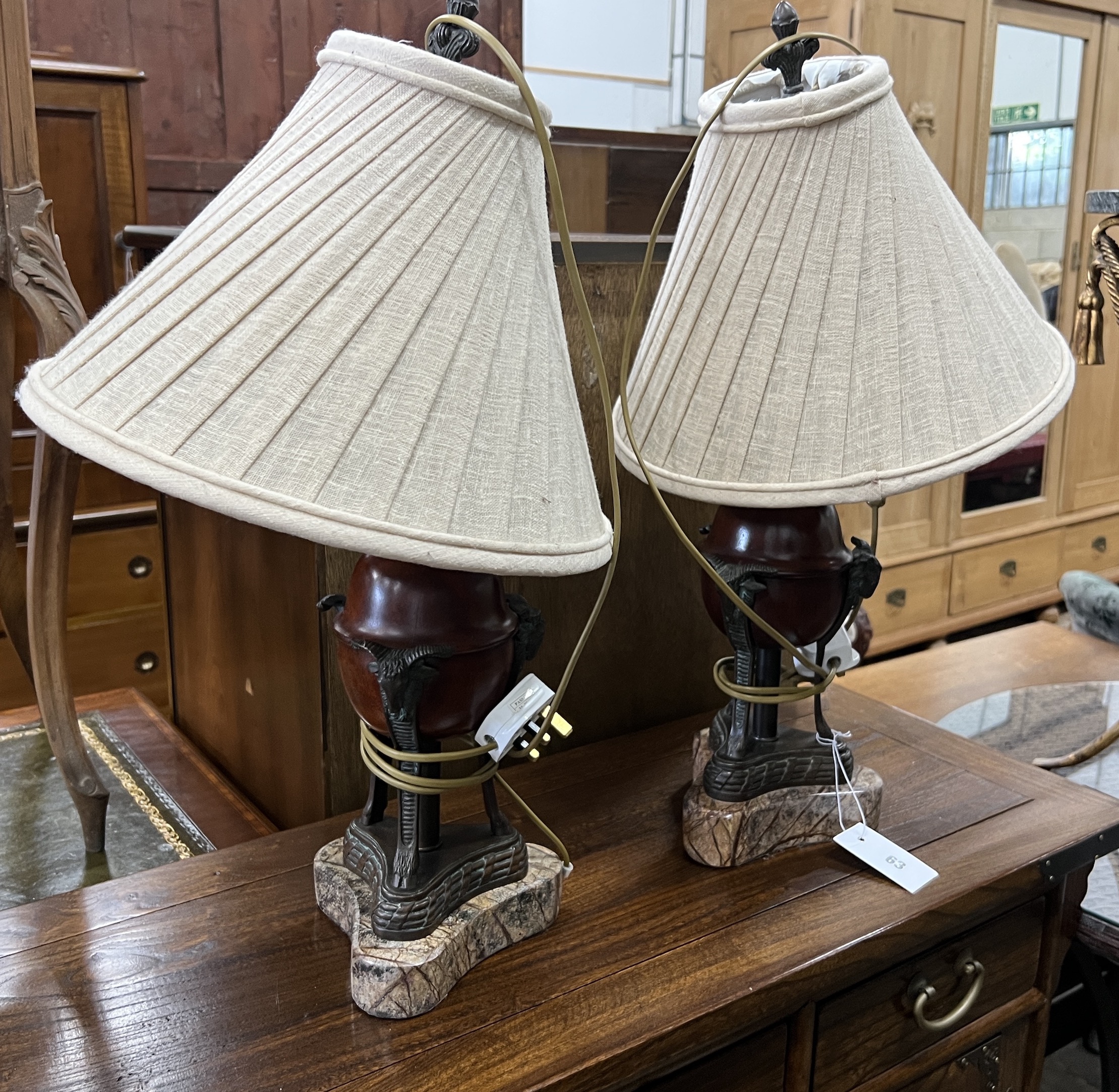 A pair of bronze effect table lamps, on faux marble bases, height including shades 60cm