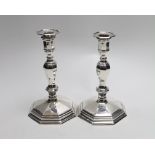 A pair of Queen Elizabeth II cast silver candlesticks, on octagonal bases, H&R, London, 1994, height