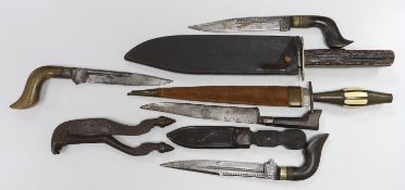 Four Islamic daggers, a small Bowie knife with horn handle, two other daggers and a pair of betel