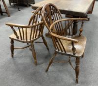 A near pair of mid 19th century Windsor yew and elm elbow chairs with crinoline stretchers, larger