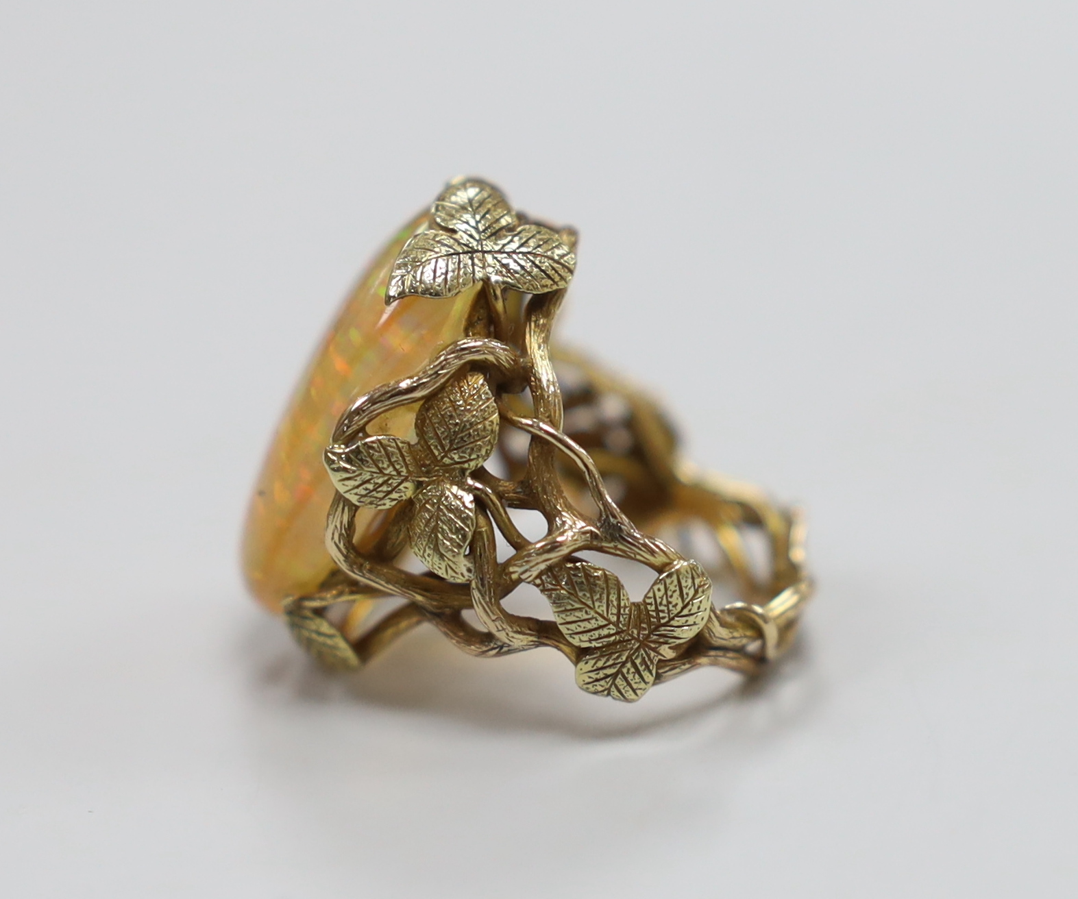 A yellow metal and oval jelly? opal set dress ring, with rustic foliate shank and setting, size L, - Image 2 of 3