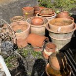 Approximately twenty five assorted terracotta garden planters, largest diameter 52cm, height 41cm