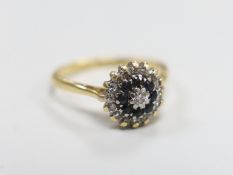 A 1960's 18ct gold, sapphire and diamond set circular cluster ring, size O, gross weight 3.7 grams.
