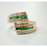 A modern 14k yellow metal, emerald and diamond chip set triple row crossover ring, size O, gross