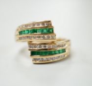 A modern 14k yellow metal, emerald and diamond chip set triple row crossover ring, size O, gross