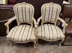 A pair of Louis VI style parcel gilt cream painted fauteuils, width 65cm, depth 52cm, height 92cm