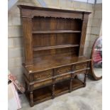 A reproduction 18th century style oak dresser with boarded rack, length 166cm, depth 48cm, height